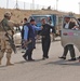 An Iraqi policeman checks the identification/registration