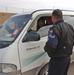 An Iraqi policeman checke the identification/registration