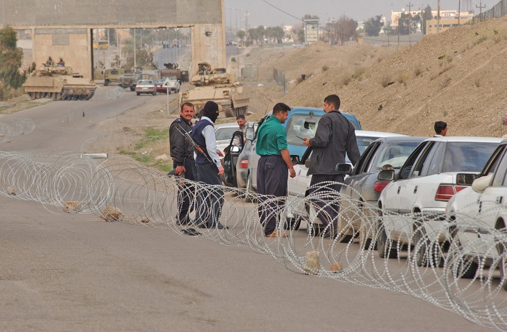 An Iraqi policeman checks the identification/registration