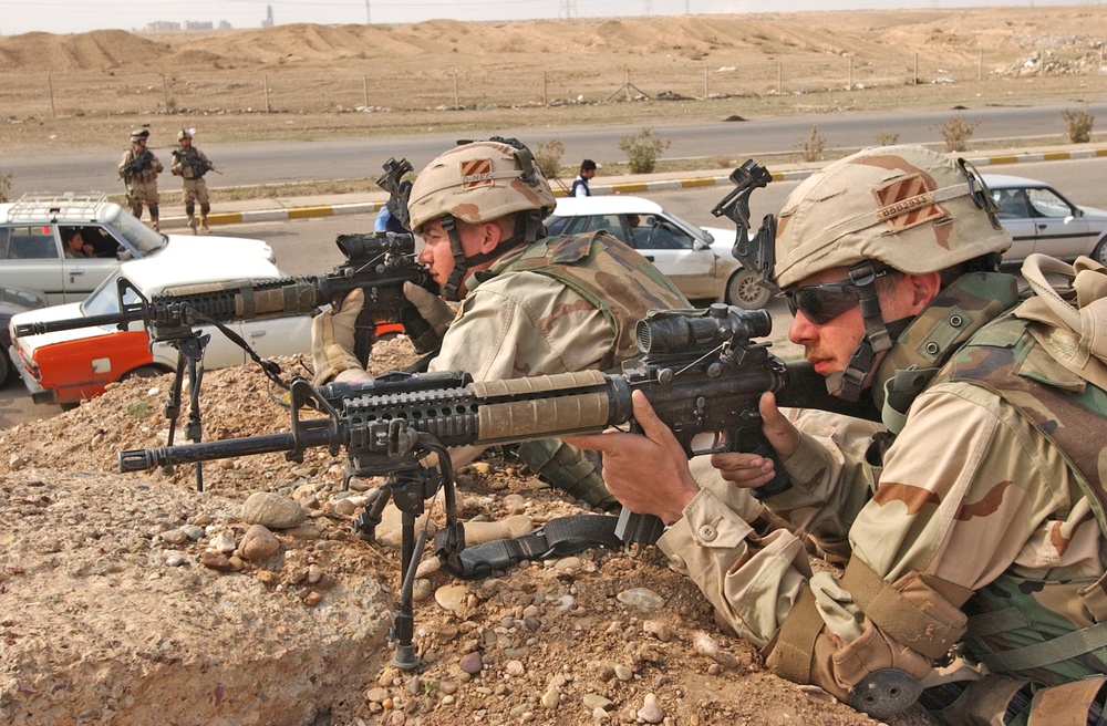 Soldiers provide overwatch to an traffic control point