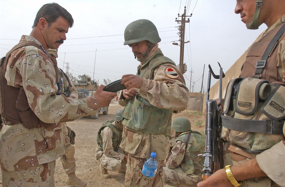 A squad leader performs a pre-combat inspection