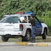 An Iraqi policeman washes his vehicle