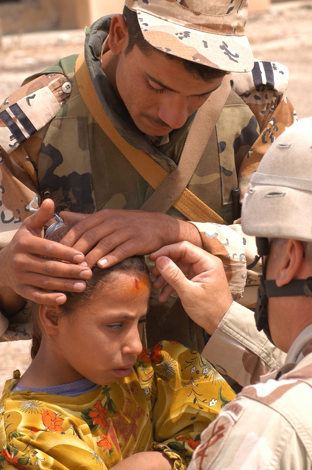 SSgt. Imperato dresses the wound of an Iraqi child