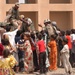 Iraqi children crowd around an Iraqi Army vehicle