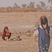 An Iraqi child watches over her share of toys