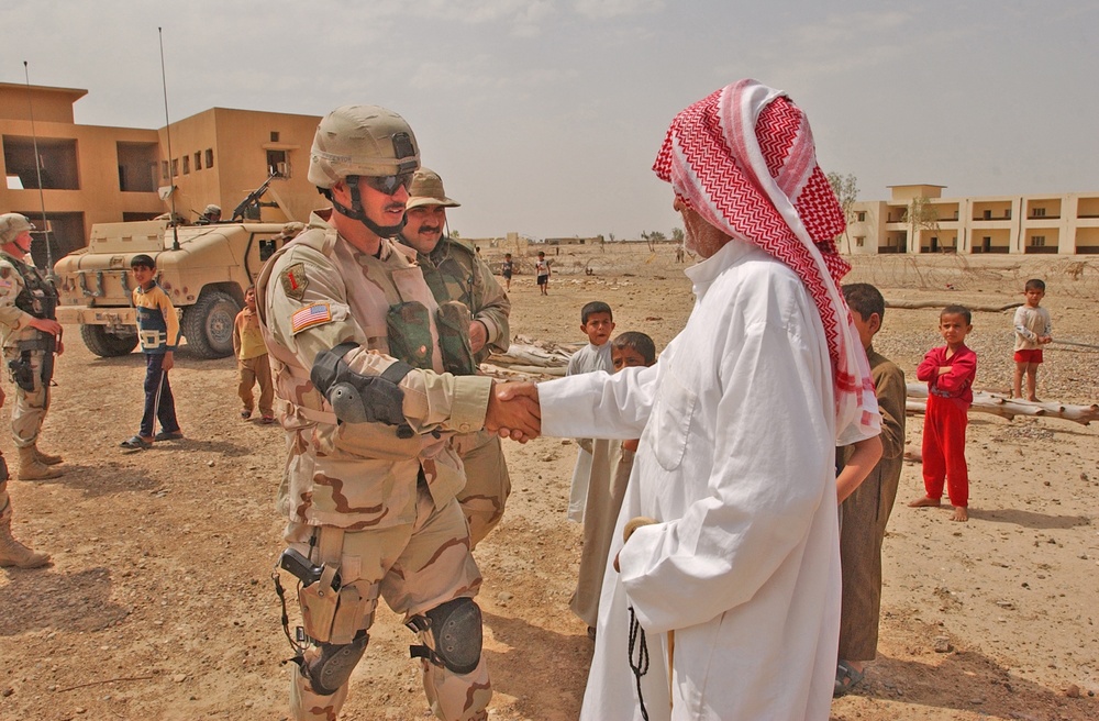 SSgt. John Imperato meets the elder of the small village