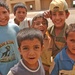 Iraqi boys gather around and play together