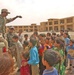 Iraqi children crowd around an Iraqi Army vehicle