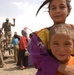 An Iraqi girl embraces her brother during a visit