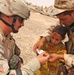 SSgt. Imperato dresses the wound of an Iraqi child