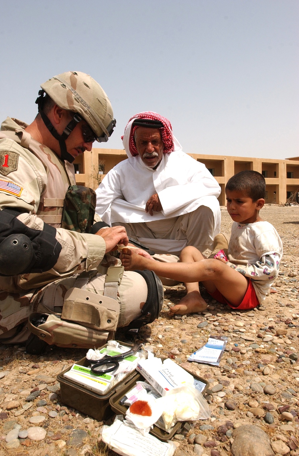 SSgt. Imperato dresses the wound of an Iraqi child