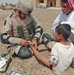 SSgt. Imperato dresses the wound of an Iraqi child