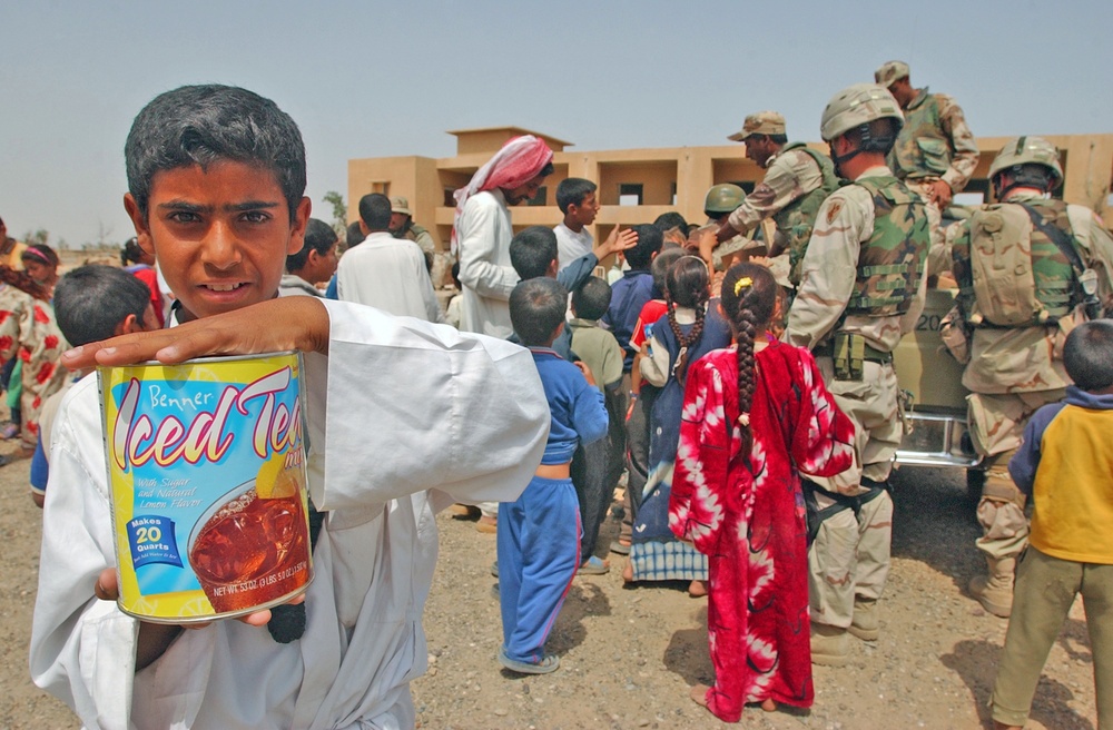 An Iraqi boy displays powdered drink mix