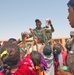 Iraqi children crowd around an Iraqi Army vehicle