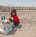 An Iraqi child watches over her share of toys/candy