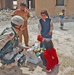 Sgt. Rothermel offers an Iraqi child a bag of candy