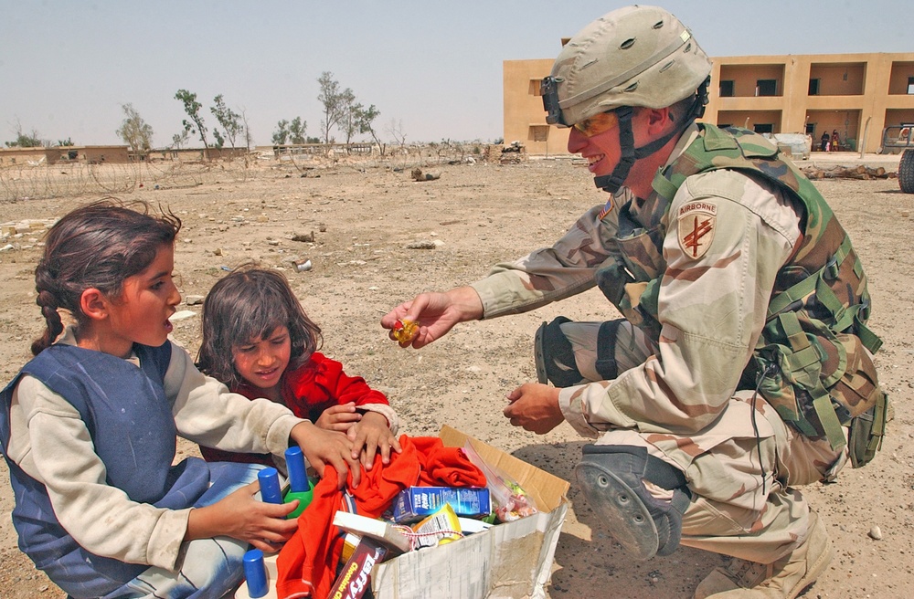 Sgt. Rothermel offers an Iraqi child a piece of candy