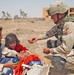 Sgt. Rothermel offers an Iraqi child a piece of candy