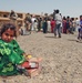 An Iraqi child guards her takings of food and toys