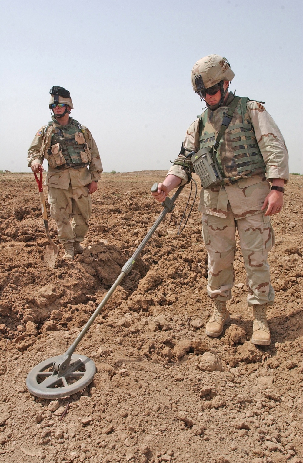 Spc. Gary Morrissey uses a mine detector to search