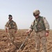 Spc. Gary Morrissey uses a mine detector to search