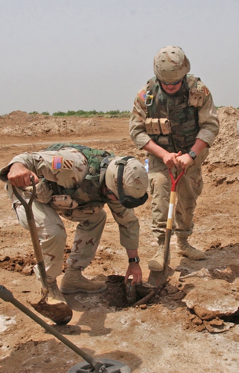 SSgt. Dennis Kradel pulls a 57mm round from a hole