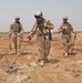 Pvt. Mark Hughes uses a mine detector to search