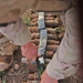 A soldier lays down C4 to destroy unexploded ordnances