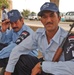 Iraqi Police recruits wait in the shade of a tree