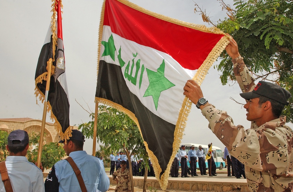 An Iraqi Police instructor checks the Iraqi Colors