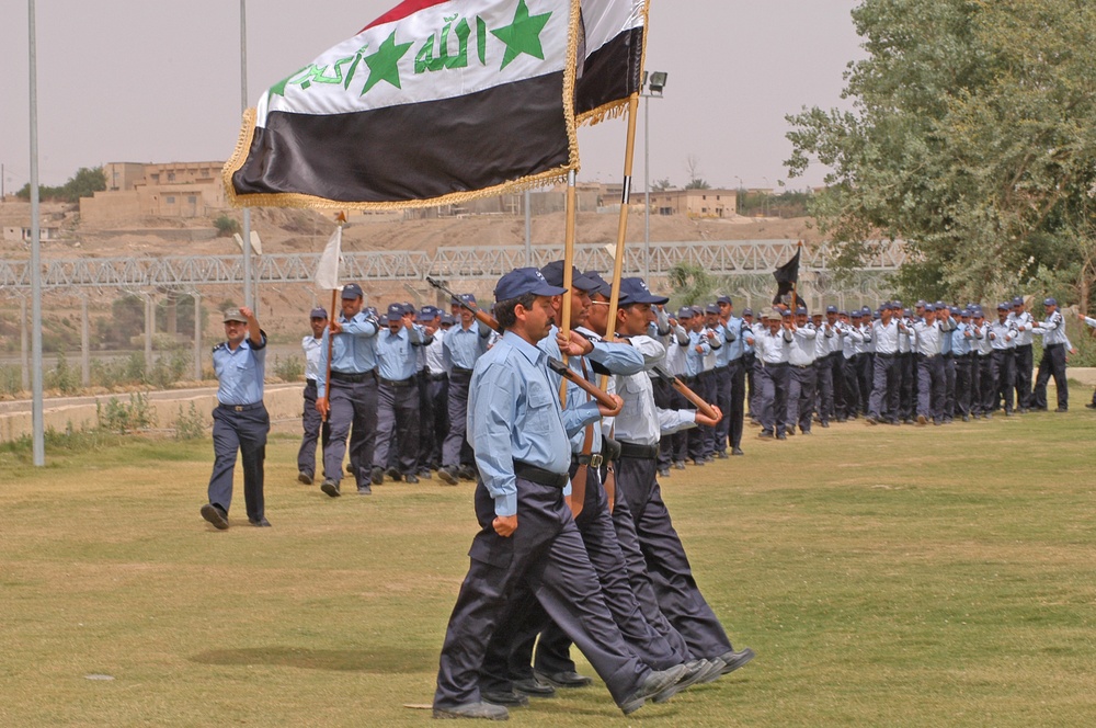 The Iraqi Color Guard leads 200 newly trained Policemen