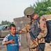 An Iraqi Army soldiers talks with an Iraqi child