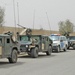 An Iraqi Highway Patrol Vehicle sits between the Humvees