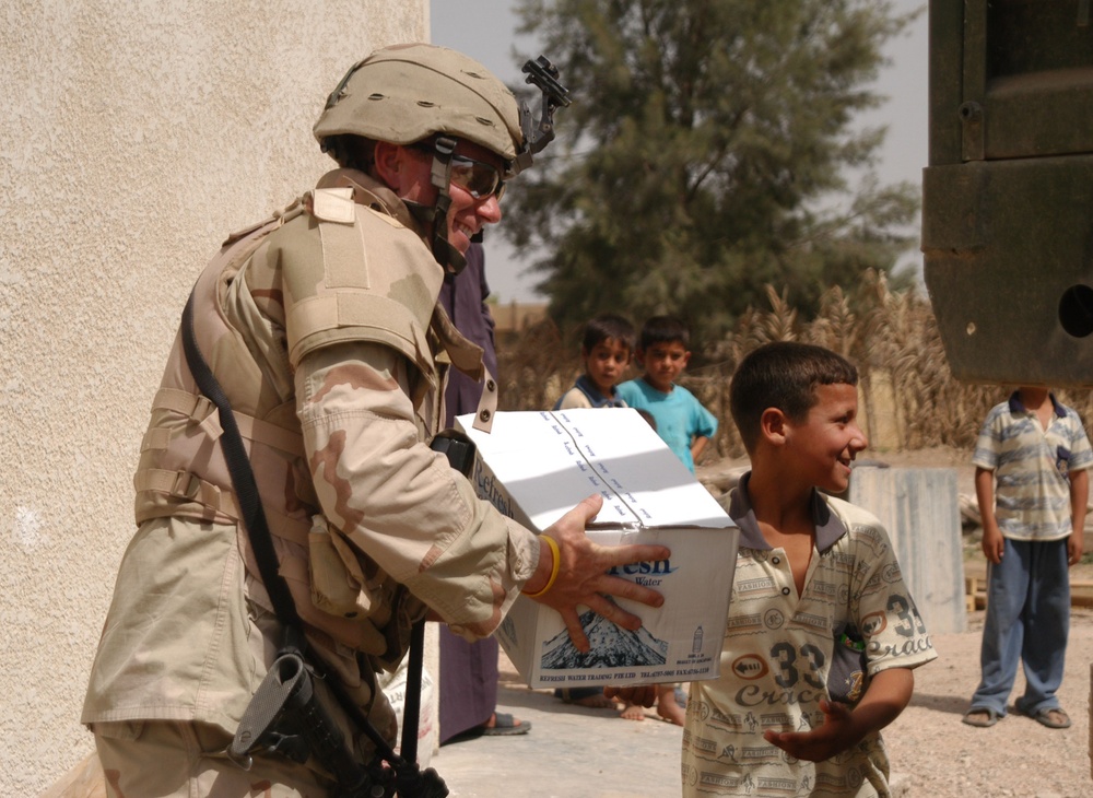 2nd Lt. Justin Otto is handed a box of bottled water