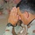 Col. Arnaldo Claudio bows his head during the benediction