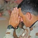 Col. Arnaldo Claudio bows his head during the benediction