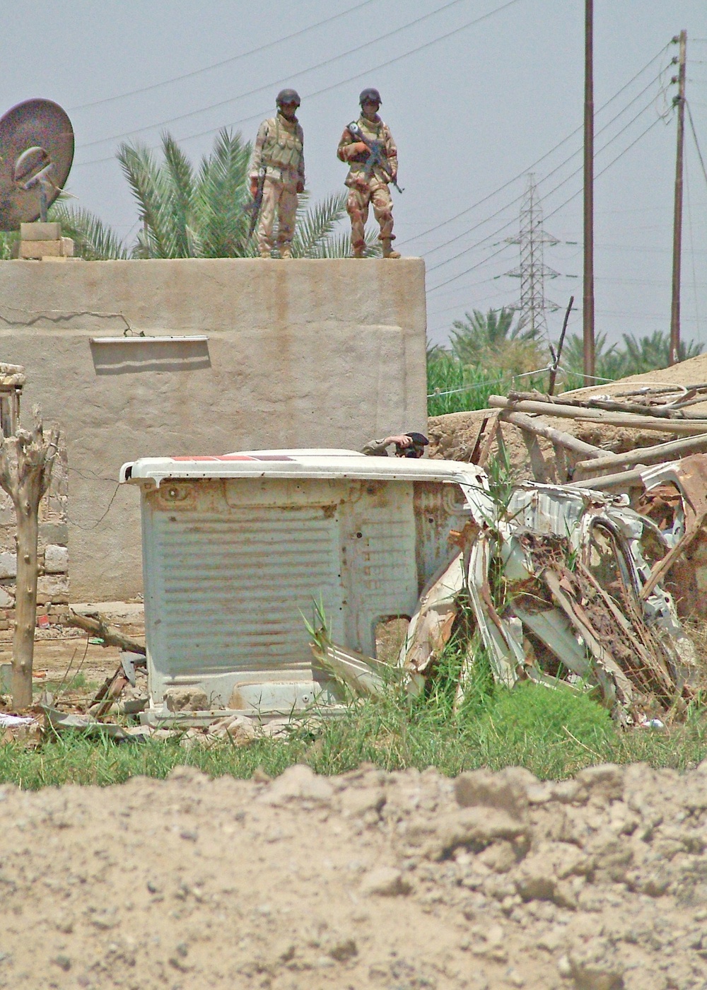 Iraqi Army Soldiers provide security from a rooftop