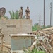 Iraqi Army Soldiers provide security from a rooftop