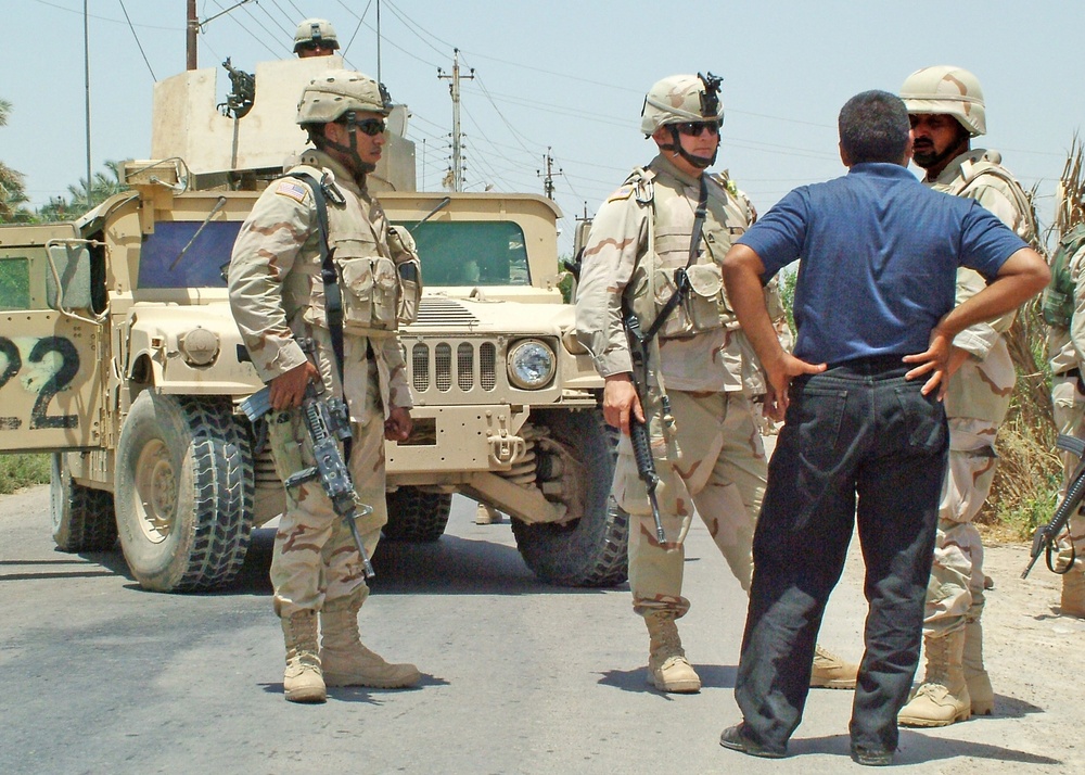 Soldiers interview a pedestrian who attempted to pass