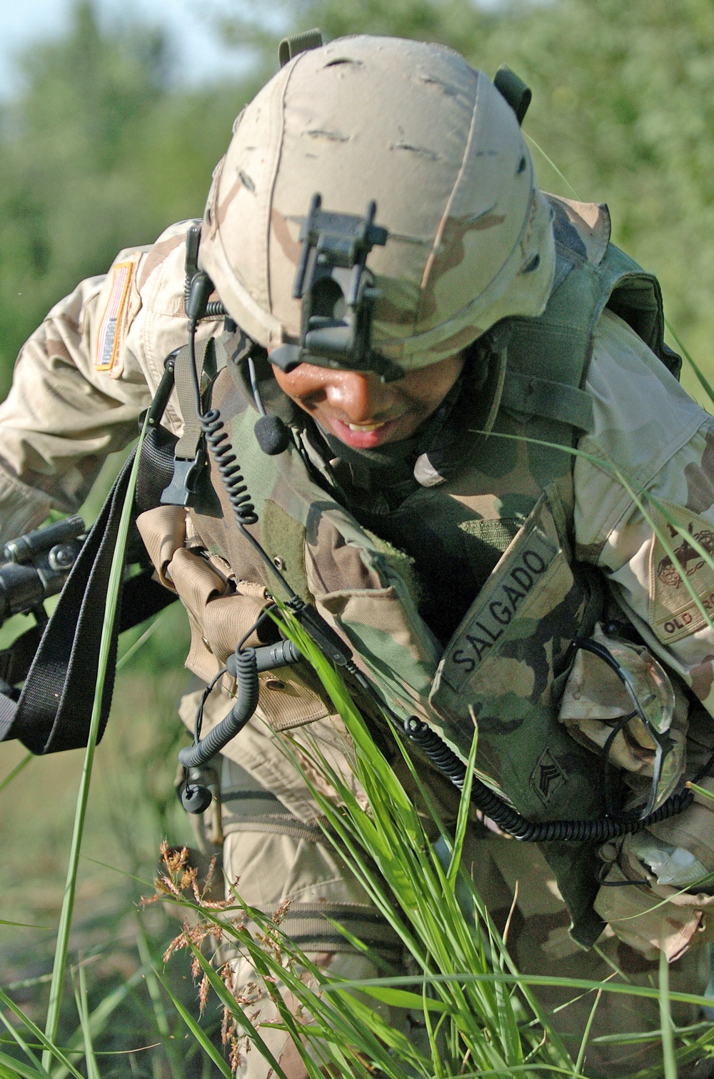 Sgt. Raymond Salgado jumps over an irrigation ditch