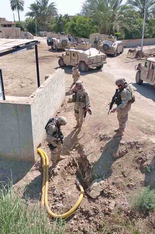 Soldiers examine a water pumping and filtration station