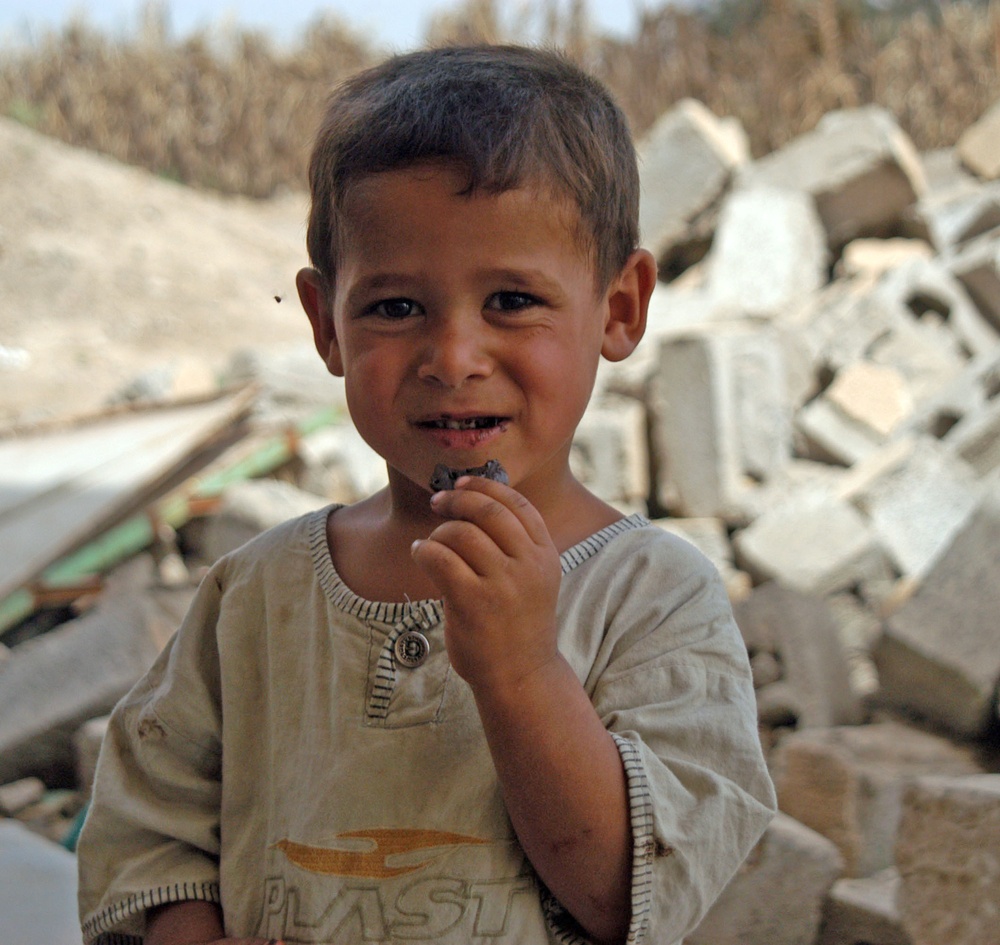 A young Iraqi boy smiles for the camera