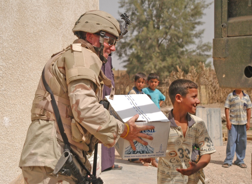 2nd Lt. Justin Otto is handed a box of bottled water