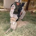 Cpl. Keith Strong pets a cheetah at the Baghdad Zoo