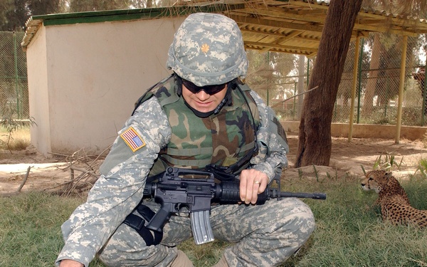 Maj. Bowman pets a cheetah at the Baghdad Zoo