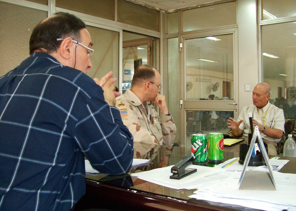An Iraqi businessman (left), Maj. Timothy Raymond (center)