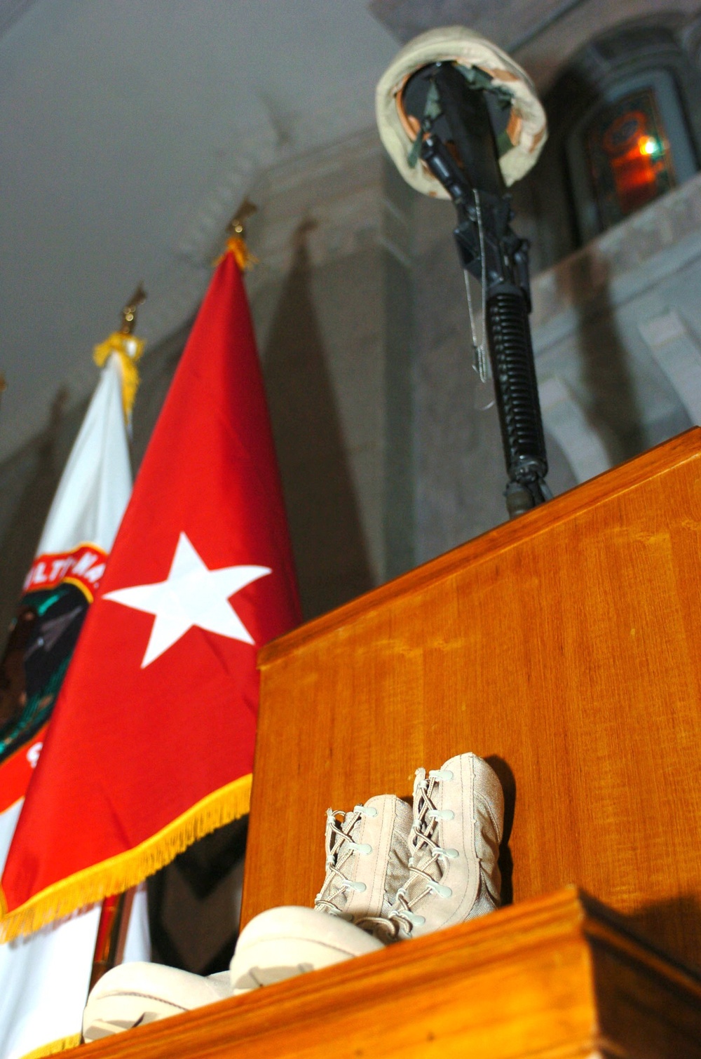 Traditional memorial of a Soldiers boots, rifle with fixed bayonet, &quot;dog&quot; t