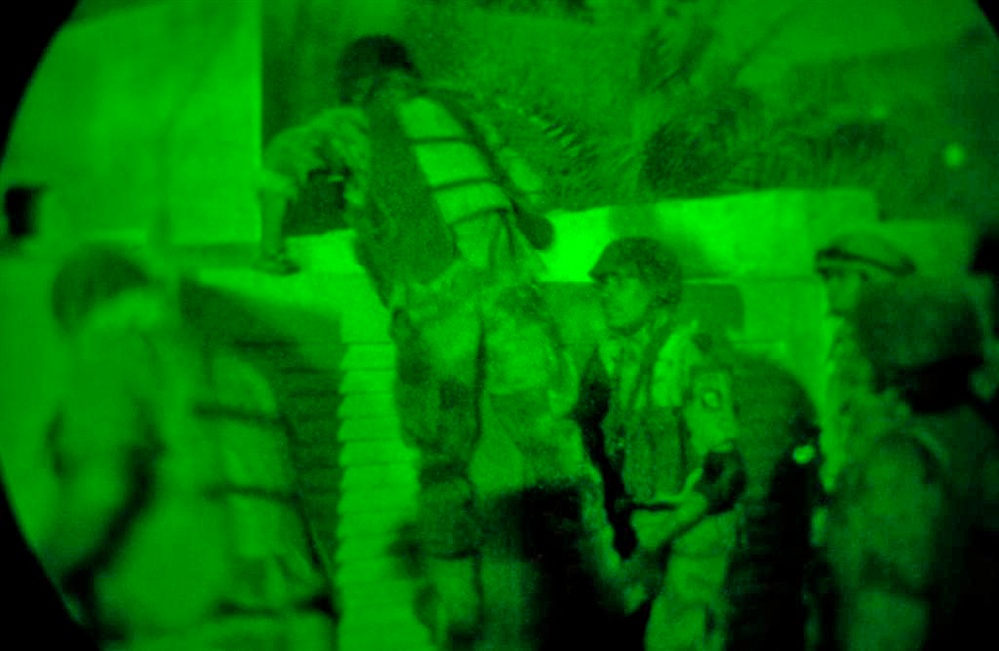 An Iraqi Soldier boosts his fellow soldier over the wall An Iraqi Soldier boosts his fellow soldier over the wall