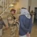 Iraqi army soldiers inspect houses and identification cards