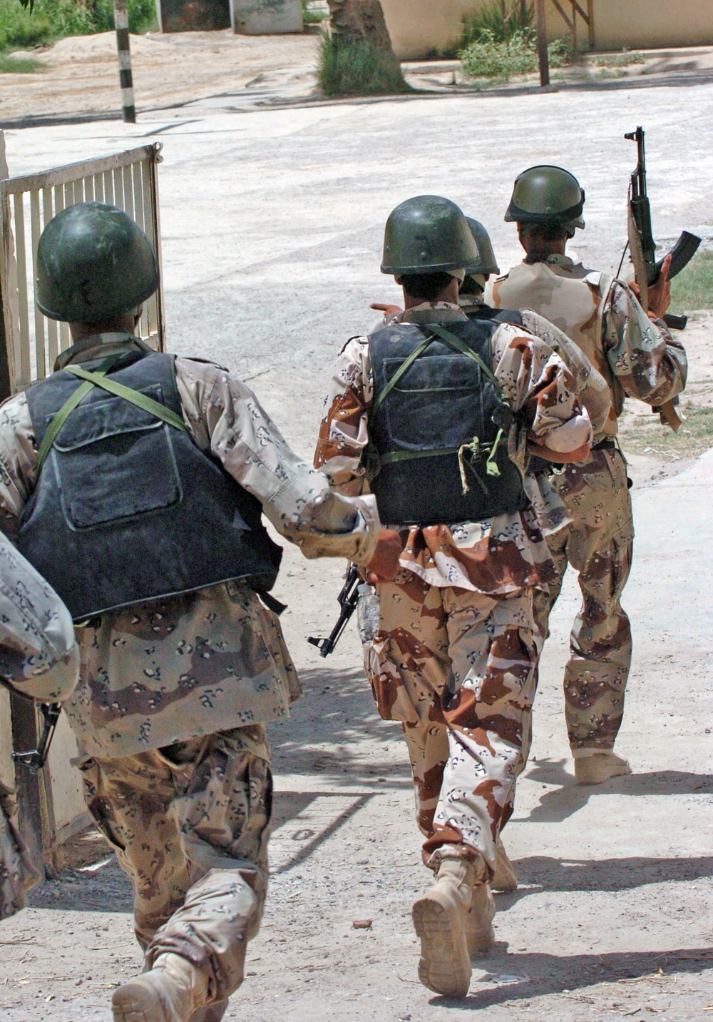 Iraqi Army enter a courtyard during a raid